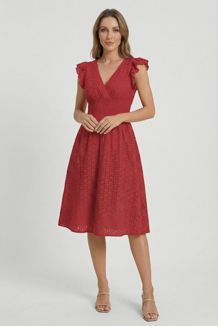 Full-length view of woman in a stylish flared eyelet midi dress with ruffled sleeves, perfect for summer elegance.