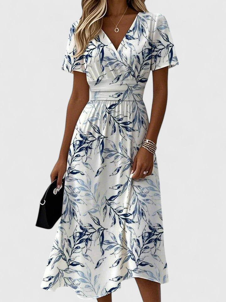 Women's white floral print midi dress with elegant wrap V-neck and flutter sleeves, perfect for summer brunch.