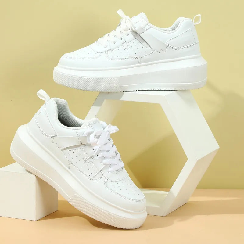 Women's white perforated platform sneakers with laces, perfect for casual fashion footwear.