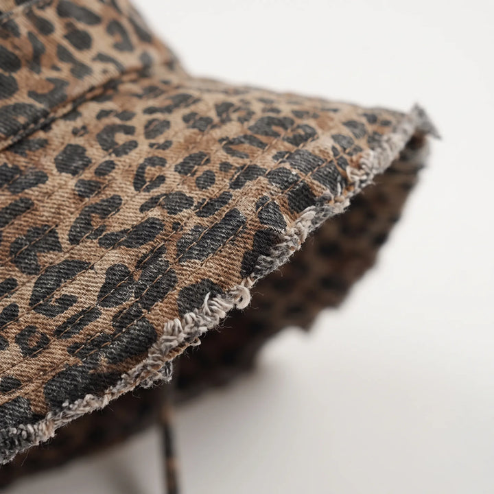 Trendy women's leopard print wide brim bucket hat for fashion-forward sun protection.