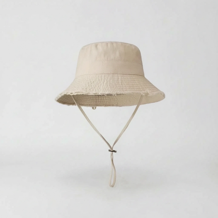 Women's wide brim bucket hat with chic frayed edge, perfect beach accessory for sun protection.