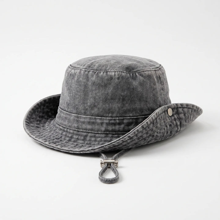 Elegant women's wide brim bucket hat, adjustable & foldable for stylish sun protection on beach trips & outdoor adventures.