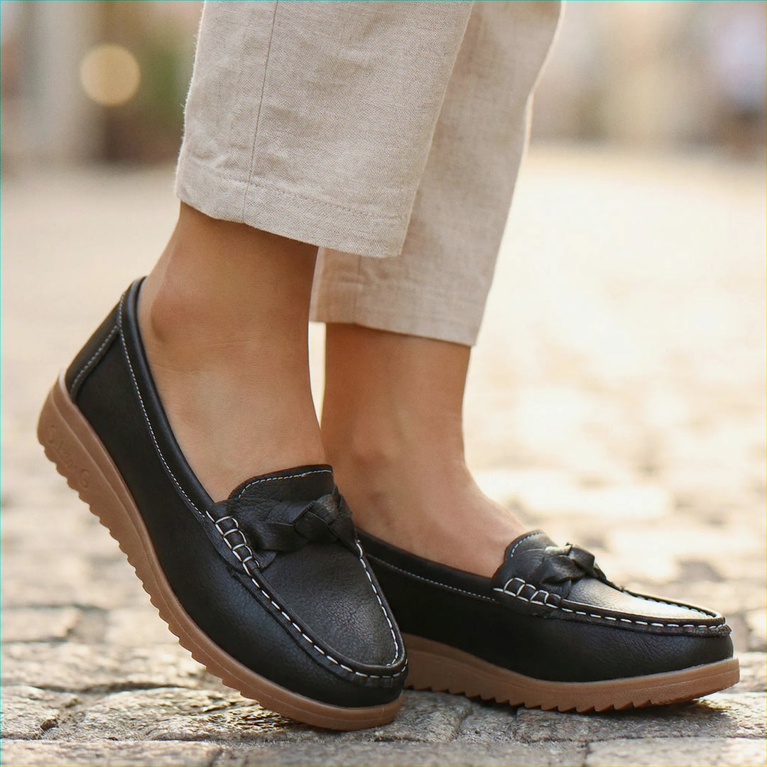 Front view of classic women's slip-on loafers, offering orthopedic comfort and wide fit for relief.