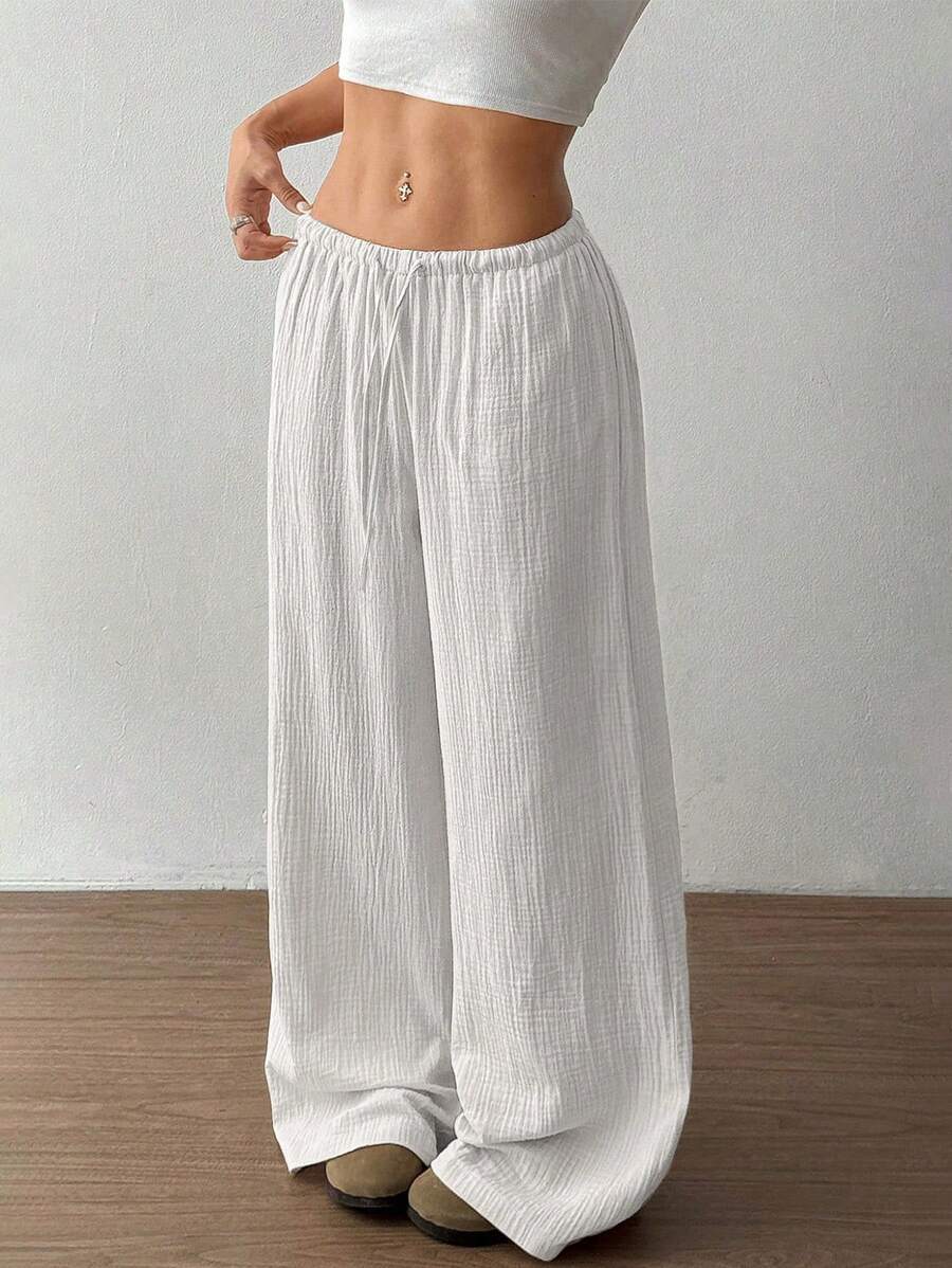 Comfortable women's wide leg pants with a crinkle texture, elastic drawstring waist. Perfect casual loungewear.