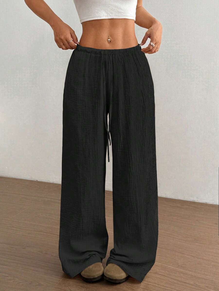 Bohemian style women's wide leg pants, crinkle texture, drawstring elastic waist. Relaxed summer fashion.
