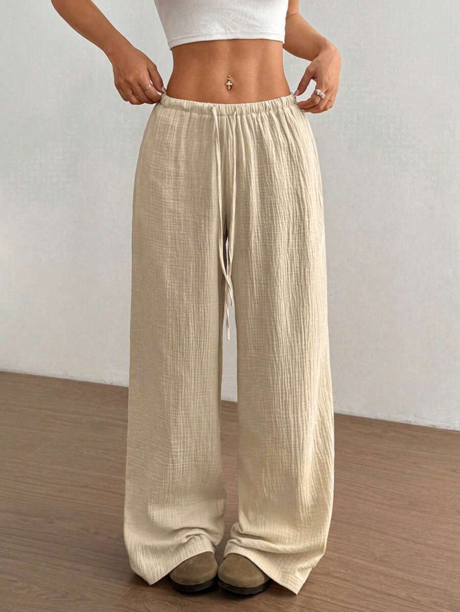 Versatile women's wide leg crinkle pants, drawstring waist. Ideal for casual wear, beach, or loungewear.