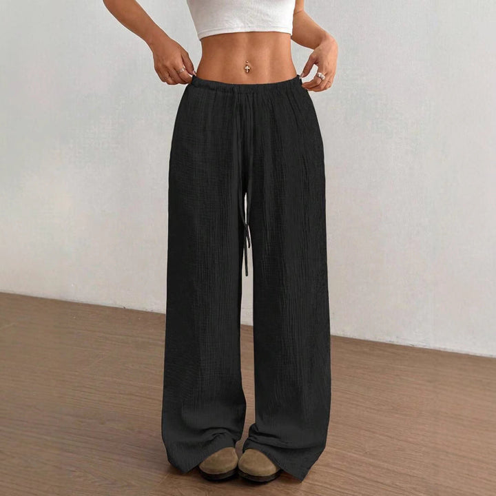 Loose fit women's wide leg pants with crinkle texture, elastic drawstring waist. Breathable summer comfort.