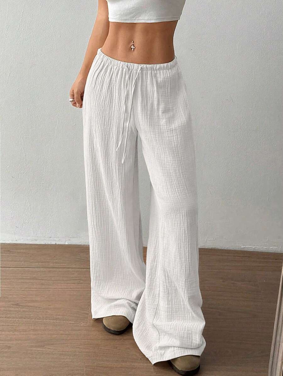Women's wide leg crinkle pants, showcasing adjustable drawstring & elastic waist for relaxed fit.