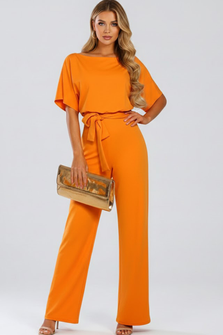 Modern women's wide leg short sleeve jumpsuit, featuring a comfortable fit & chic belt. Versatile outfit.