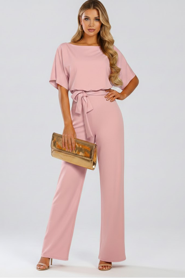 Full length view of a women's elegant wide leg short sleeve jumpsuit with a flattering belted waist.