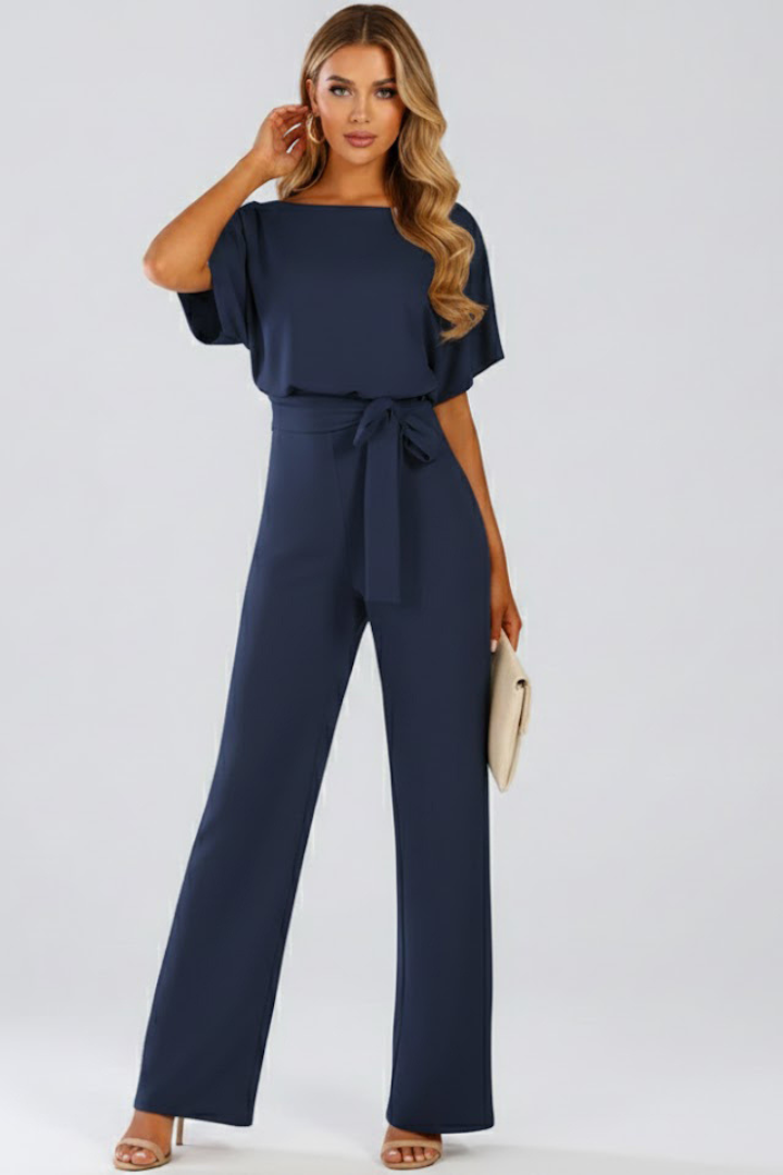 Soft, flowy fabric of a women's wide leg short sleeve jumpsuit with a belt, ensuring comfort & style.