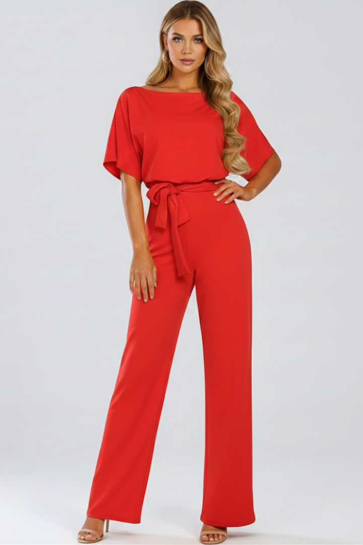 Woman in a stylish wide leg short sleeve belted jumpsuit. Comfortable & elegant for spring/summer days.