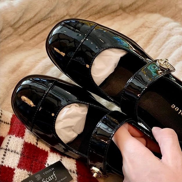 Women's classic black Mary Jane flats featuring wide toe box & arch support.