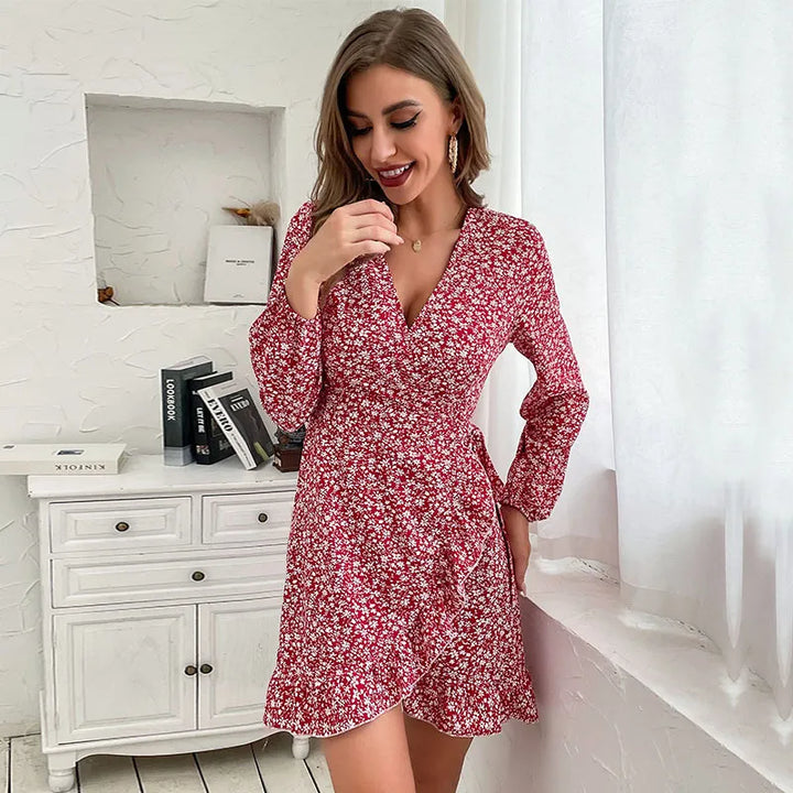 Stylish women's wine red V-neck floral wrap mini dress. Ruffled long sleeve design with tie waist, ideal for casual wear.