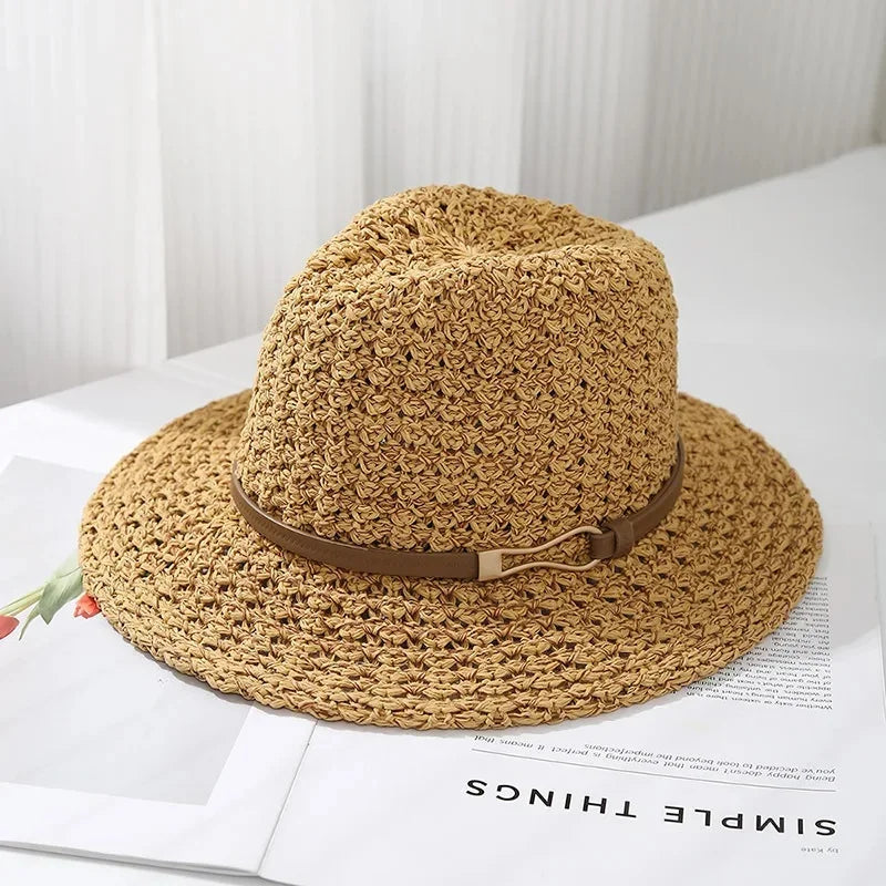 Women's woven fedora sun hat with a wide brim and faux leather band; an essential summer beach accessory.