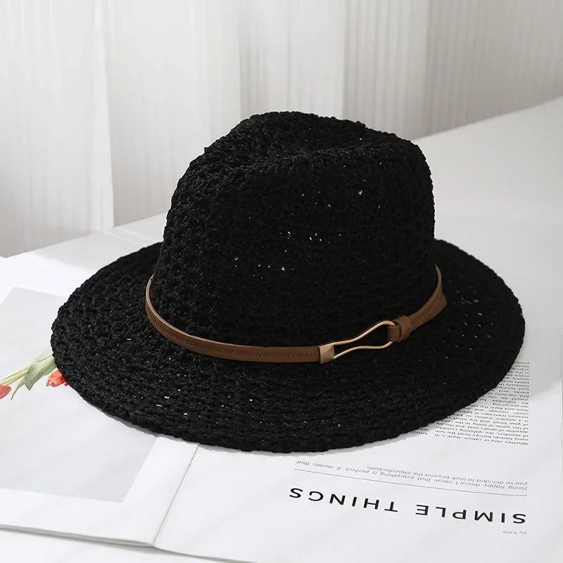 Women's vacation accessory: a wide brim woven fedora sun hat, featuring a faux leather band for beach style.