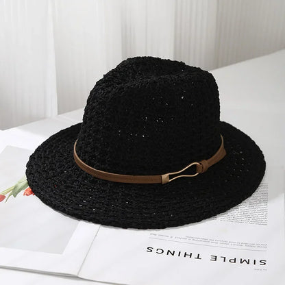 Women's vacation accessory: a wide brim woven fedora sun hat, featuring a faux leather band for beach style.