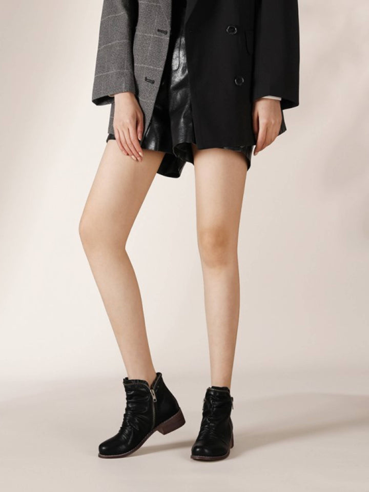 Wrinkled black women's ankle boots with practical double zippers and a comfortable low Western heel.