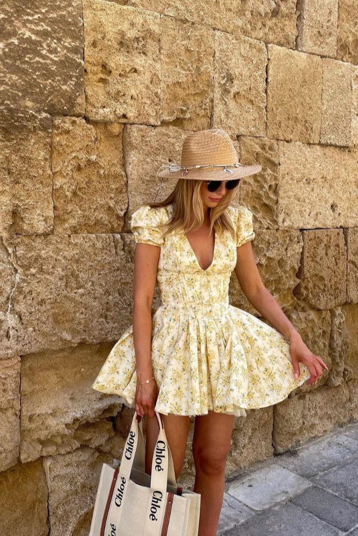 Casual-chic floral mini dress for women, yellow, puff sleeves, open back. Summer essential.