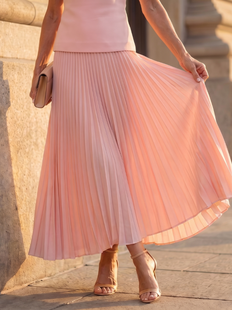 Women's sky blue pleated maxi skirt and matching structured bodice top, a chic two-piece set.