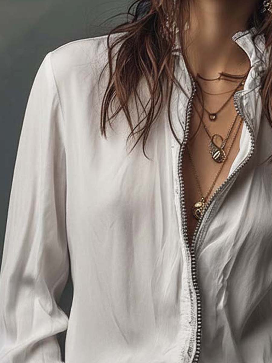 Tailored women's top: zip-front design, long sleeves, and trendy bell cuffs.