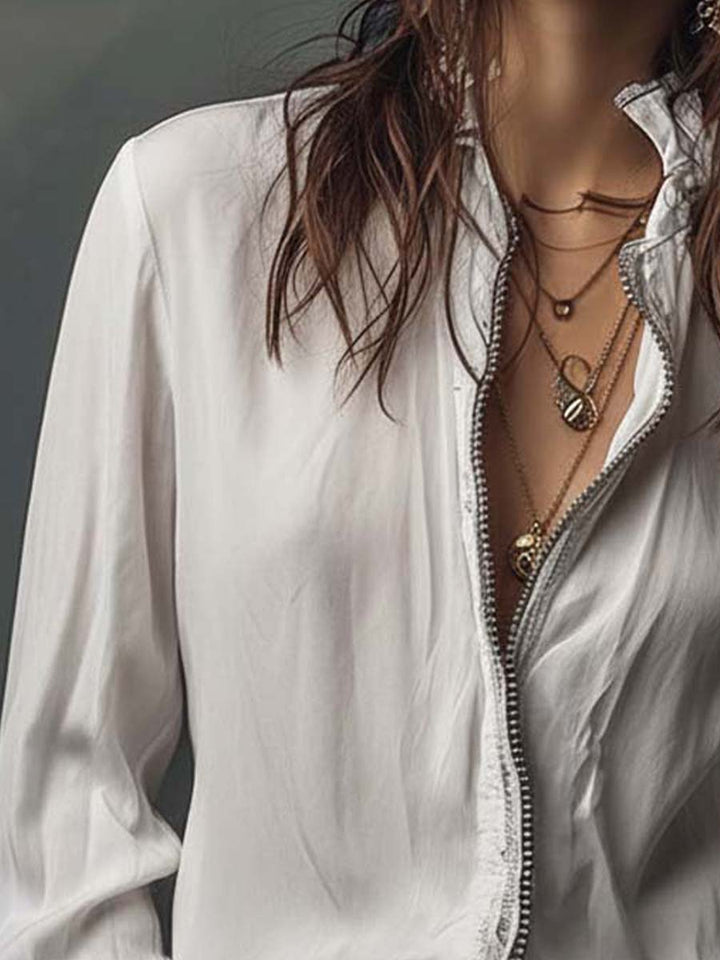 Tailored women's top: zip-front design, long sleeves, and trendy bell cuffs.