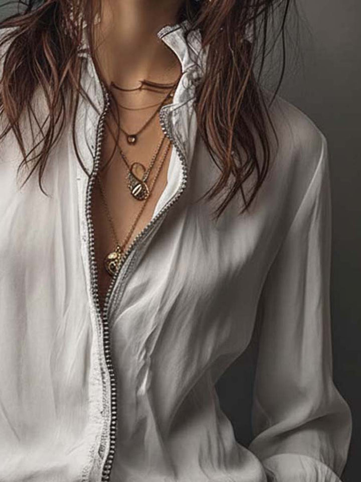 Fashionable women's blouse, zip-up front, long bell sleeves, casual chic style.