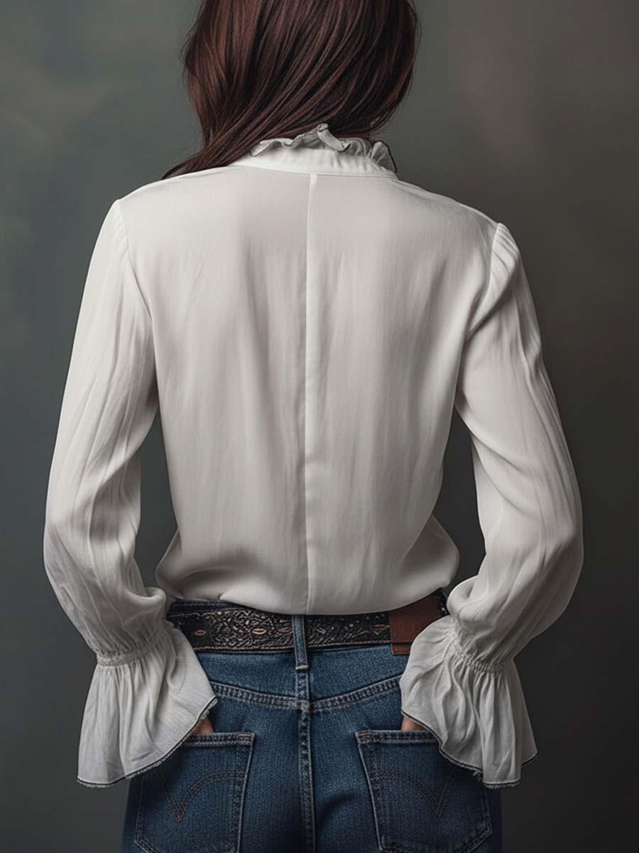 Sophisticated women's long-sleeve blouse with a modern zip front & bell cuffs.