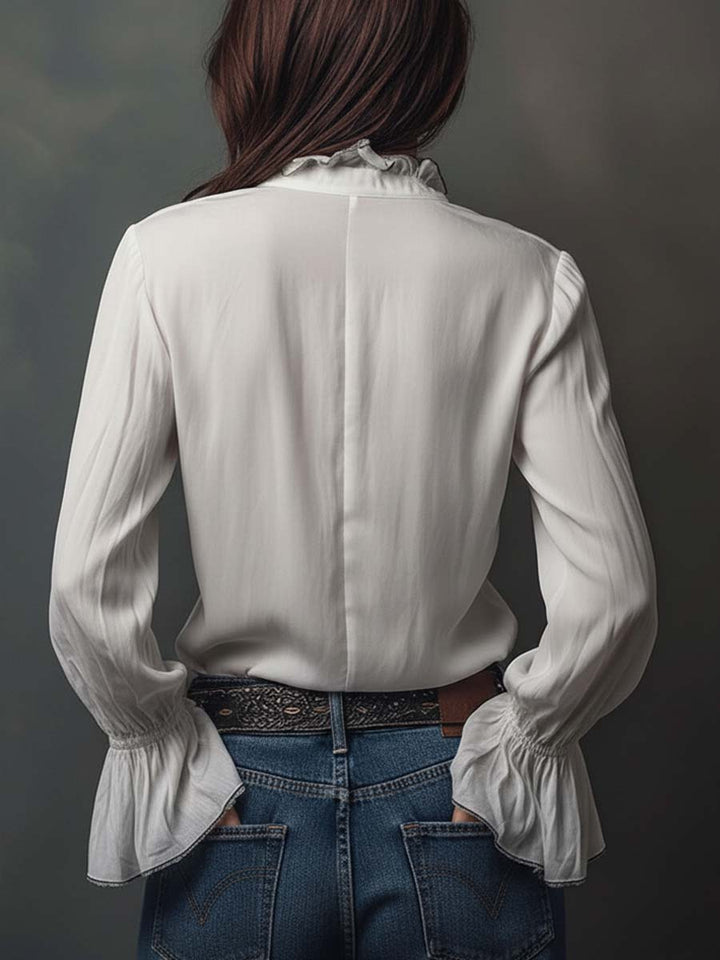 Sophisticated women's long-sleeve blouse with a modern zip front & bell cuffs.