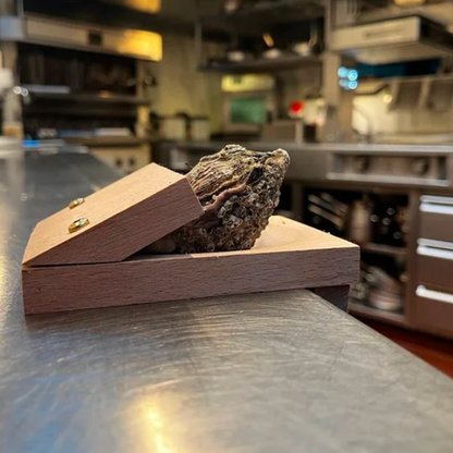 Securely shuck oysters with this wooden clamp, a safe & easy seafood opener kitchen tool.