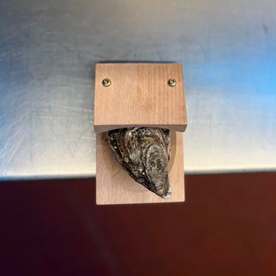 Smart wooden oyster shucking clamp; a safe, indispensable kitchen tool for seafood lovers.