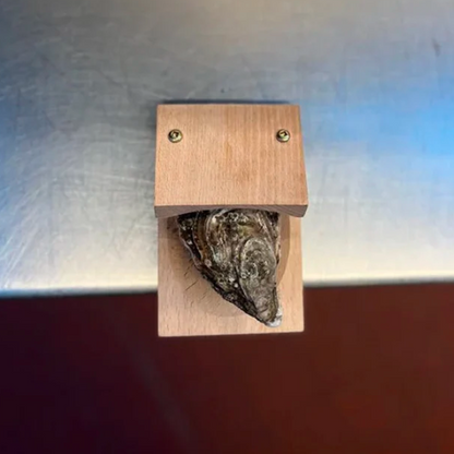 Smart wooden oyster shucking clamp; a safe, indispensable kitchen tool for seafood lovers.