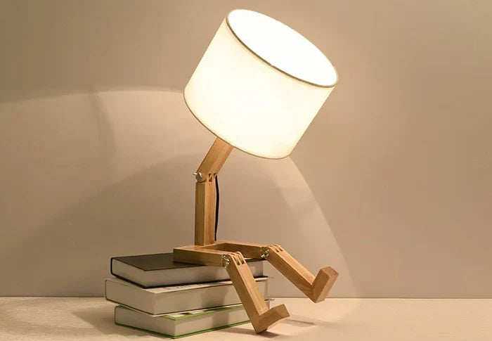 Modern wooden robot desk lamp, a unique decorative lighting piece with a clever book holder feature.