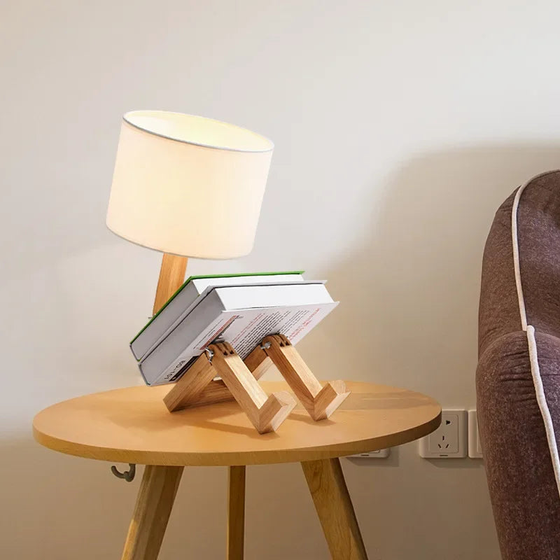 Decorative wooden robot lamp, a unique table lamp with an integrated book holder for modern home accents.
