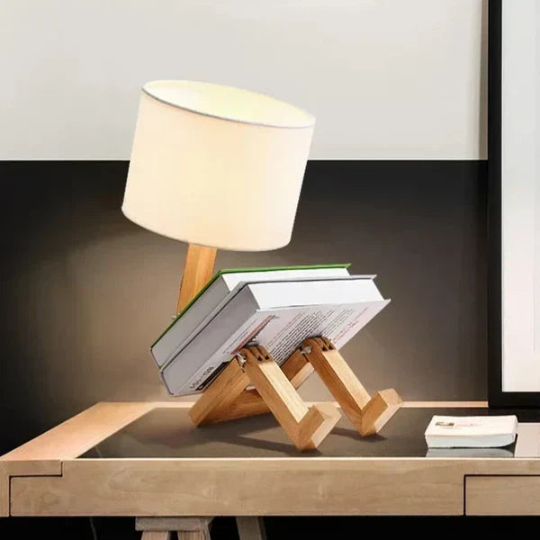 Versatile wooden robot table lamp, an adjustable desk lamp with a convenient book holder for any room.