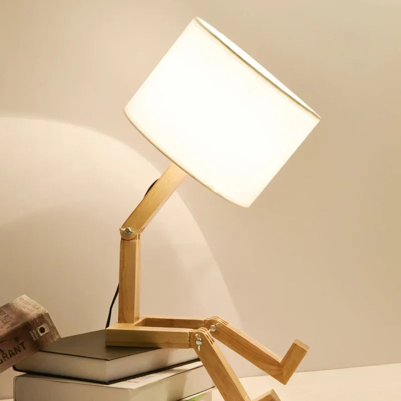 Stylish wooden robot reading lamp with an integrated book holder, a unique decorative piece for modern desks.