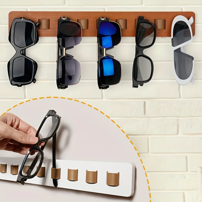 Wooden wall-mounted glasses display rack with genuine leather hangers for organized eyewear storage.