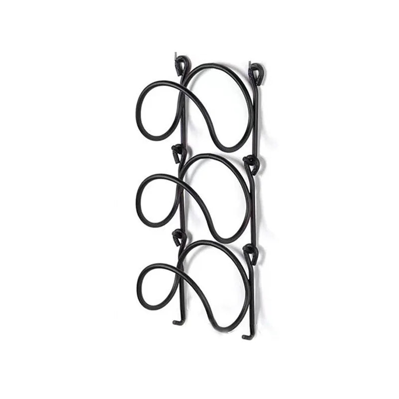 Elegant wrought iron multi-layer towel rack, ideal for a spa bathroom, enhancing wall decor & storage.