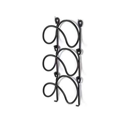 Elegant wrought iron multi-layer towel rack, ideal for a spa bathroom, enhancing wall decor & storage.
