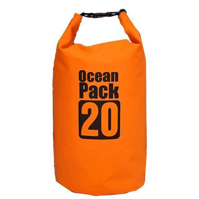 Group of friends with waterproof dry bags on a beach, ready for water activities.